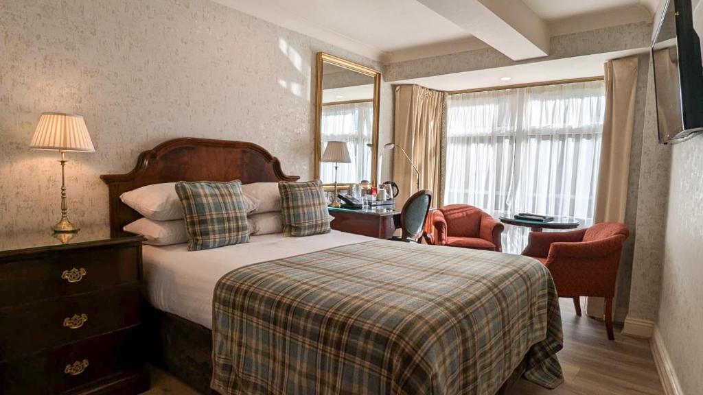 Postel nebo postele na pokoji v ubytování Granville Hotel