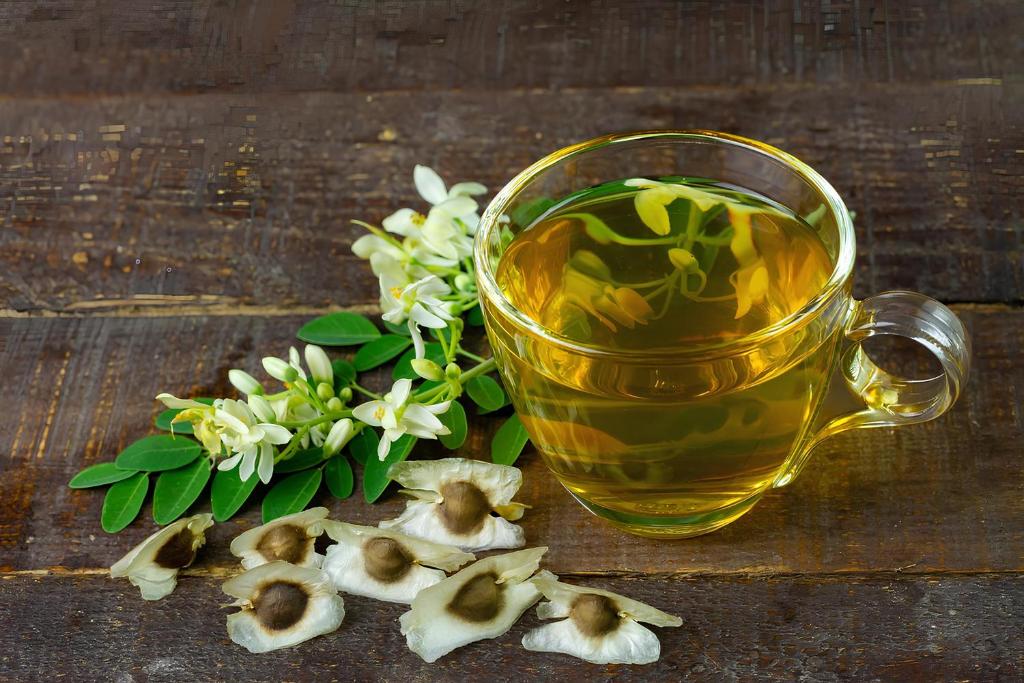a cup of herbal tea and flowers on a wooden table at Crab Bui Vien Homestay in Ho Chi Minh City