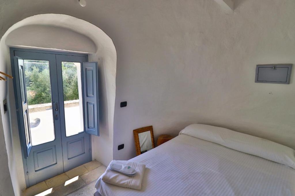 Postel nebo postele na pokoji v ubytování Masseria Trullo Sovrano Exclusive B&B