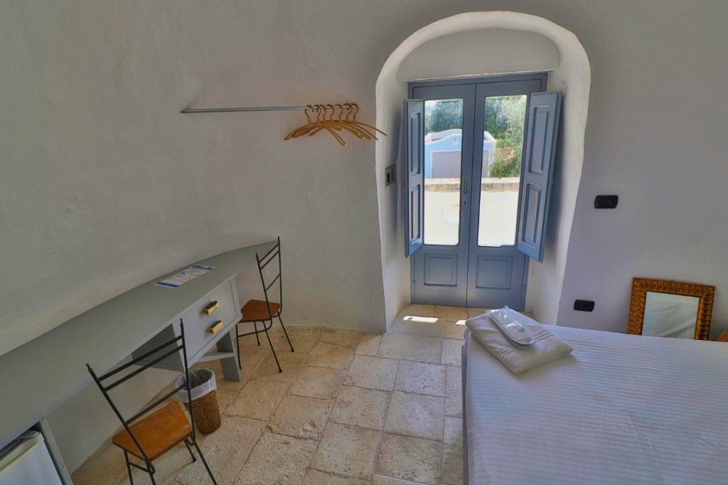 Postel nebo postele na pokoji v ubytování Masseria Trullo Sovrano Exclusive B&B