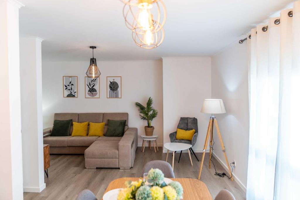 a living room with a couch and a table at Apartamento Verde Atlântico in Ponta Delgada
