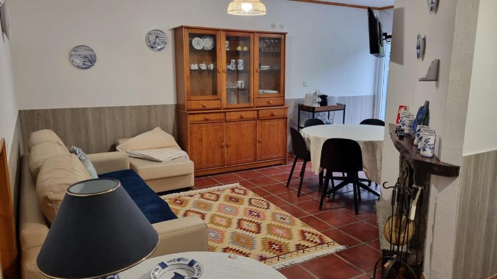 a living room with a couch and a table at Casa da Beija - House Azores in Furnas