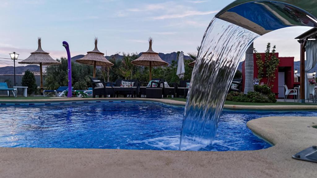 a water fountain in the middle of a pool at Villa Adelina en Turre, Almería, Villa de lujo con piscina privada cerca de las playas de Mojácar in Turre