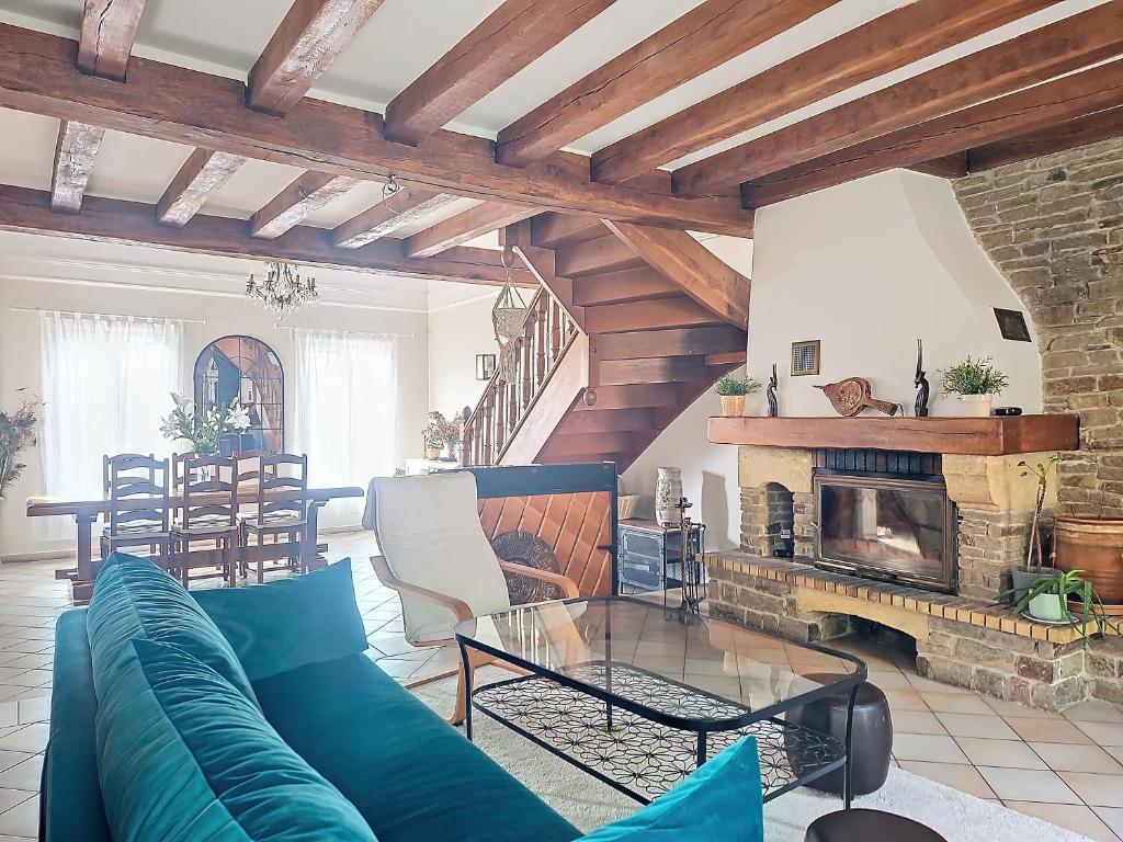 a living room with a couch and a fireplace at Maison familiale in Rueil-Malmaison