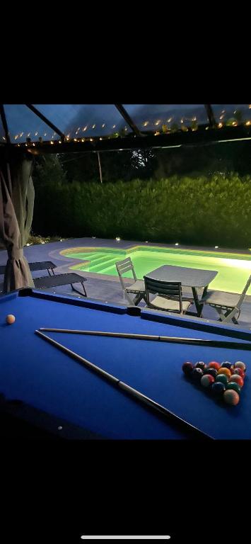 - une table de billard avec deux cannes dans l'établissement BY NEPTUNE - La Maison Courtenay Piscine Privée, 4 Chambres, à Courtenay