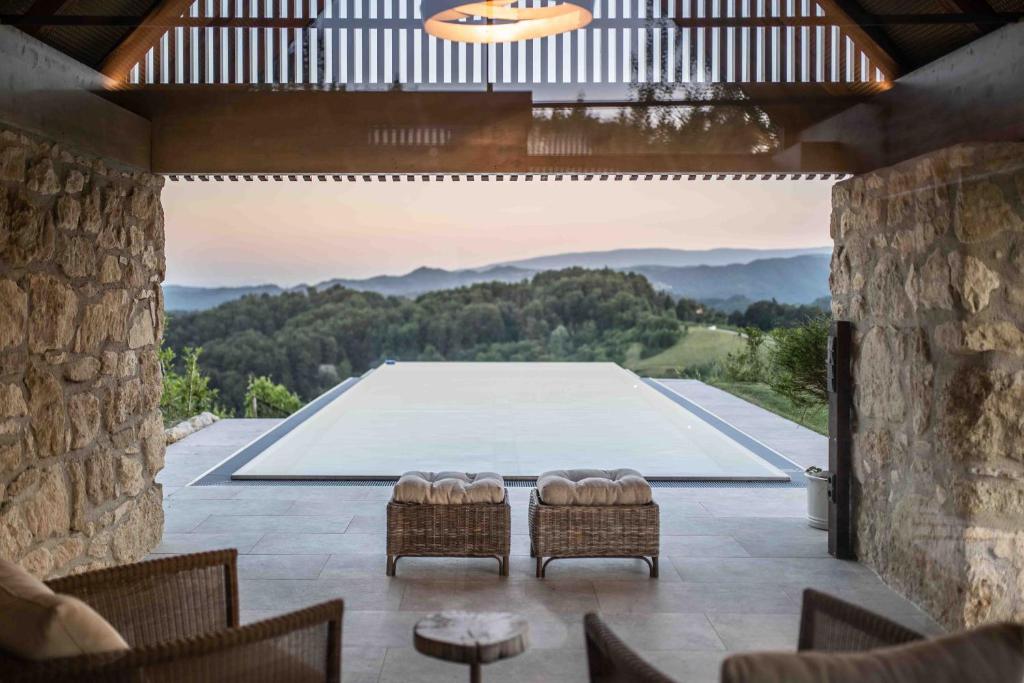 a view of a pool from a patio with two chairs at Winzarei Ciringa Stampfer in Svečina