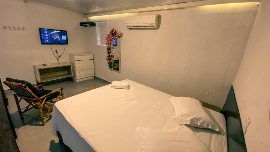 a hospital room with a bed and a tv at Pousada Ametista Sorriso in Sorriso