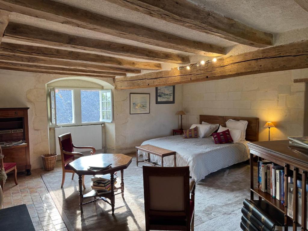 a bedroom with a bed and a desk and a table at Le Clos Marie in Fontaine-Milon