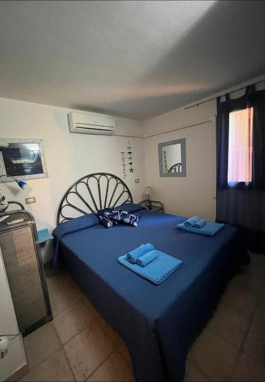 A bed or beds in a room at VILLA VITTORIA with PRIVATE HEATED SWIMMING POOL COMPLETE WITH HIDROMASSAGE FOR EXCLUSIVE USE , SEA VIEW, 150 METERS FROM THE BEACH