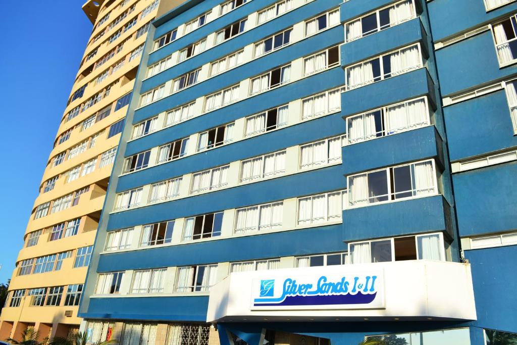 a tall blue building with a sign in front of it at Gooderson Leisure Silver Sands 1 Self Catering and Timeshare Lifestyle Resort in Durban