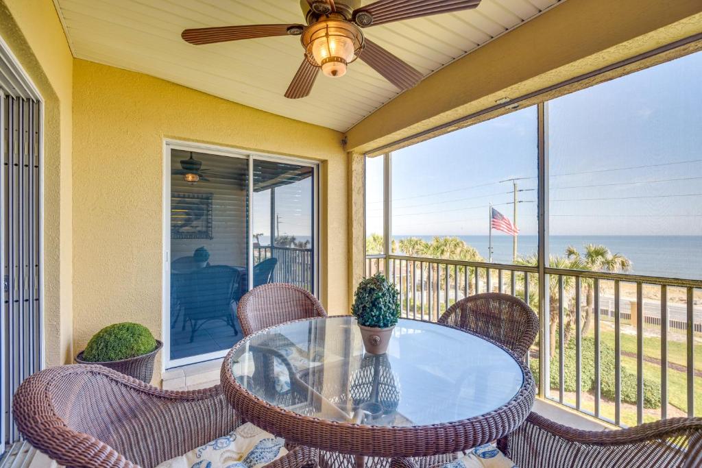 a table on a balcony with a view of the ocean at Community Pool Coastal Escape in Flagler Beach in Flagler Beach