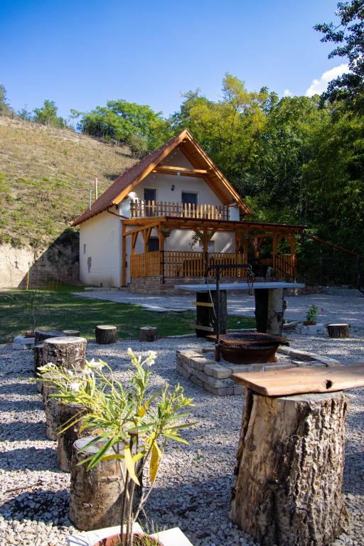 a log cabin with a porch and a deck at Forest Cottage 2024 in Lábatlan