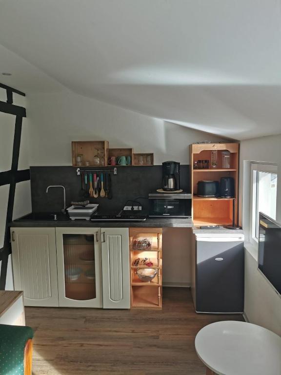 a kitchen with white cabinets and a black counter top at Ruridylle IV in Simmerath