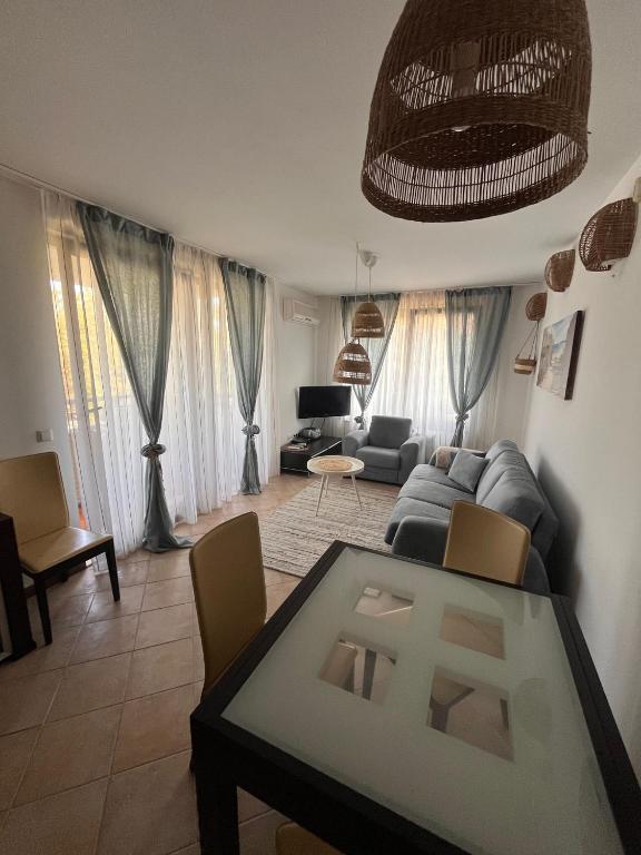 a living room with a couch and a table at Oasis Resort Apartments in Lozenets
