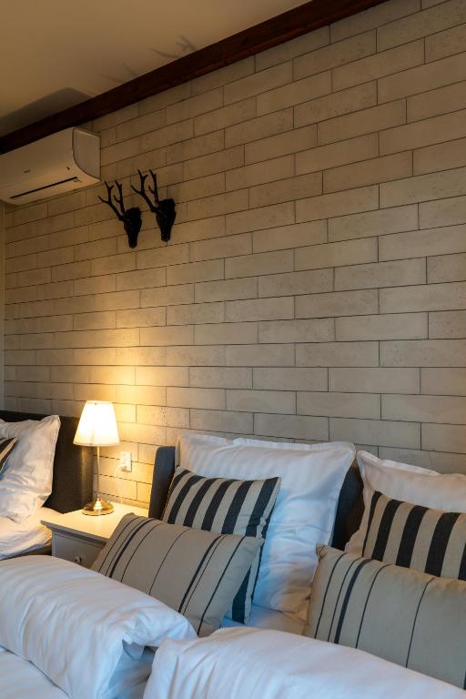 a group of pillows lined up against a brick wall at Villa la Olive Premium Apartaments-Luxury Standard in Oświęcim