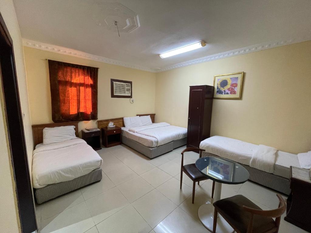 Ένα ή περισσότερα κρεβάτια σε δωμάτιο στο Saba Furnished Apartments