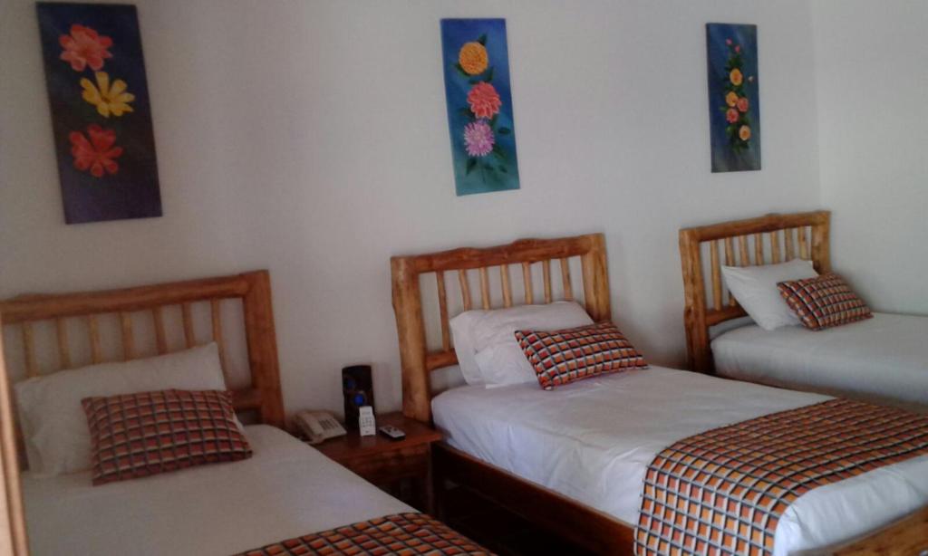 Postel nebo postele na pokoji v ubytování Hotel Brisas La Gaviota Mariquit-Tolima