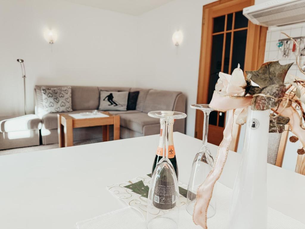 two wine glasses on a counter in a living room at Alpenquartier Montafon in Tschagguns