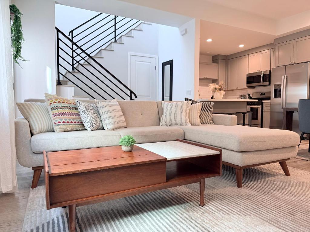 a living room with a couch and a coffee table at Modern Family Haven - Minutes from Disney Magic-OC in Midway City