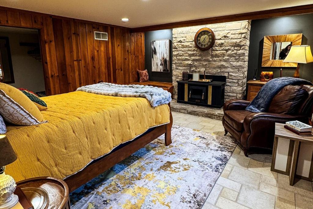 a bedroom with a bed and a couch and a chair at TU CASA-pooltable-playset-sauna in Willmar