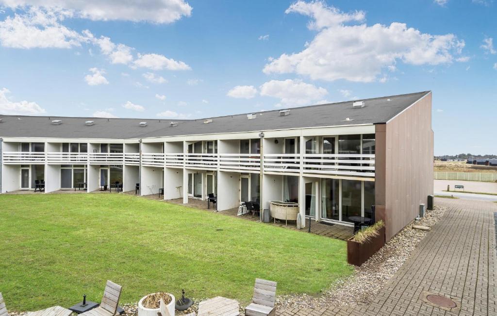 a large building with a lawn in front of it at Stunning Apartment In Ringkøbing in Ringkøbing