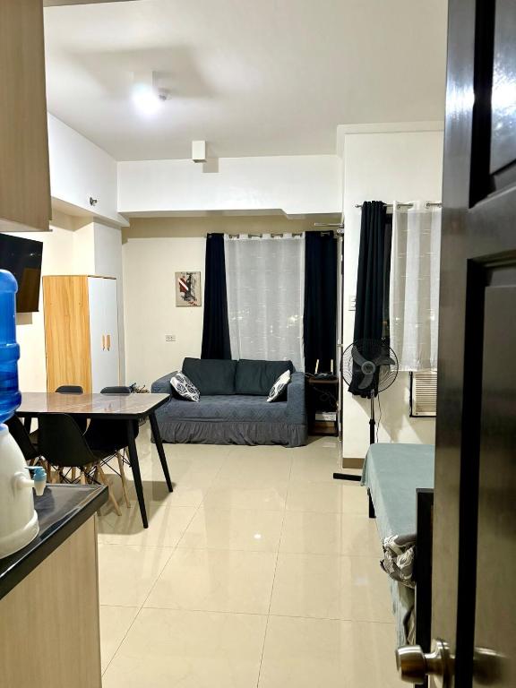 a living room with a couch and a table at Mabolo Garden Flats 2312 in Cebu City