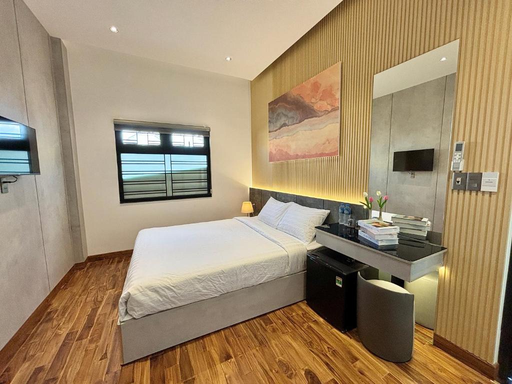 Postel nebo postele na pokoji v ubytování CEVA Hotel & Apartment Danang