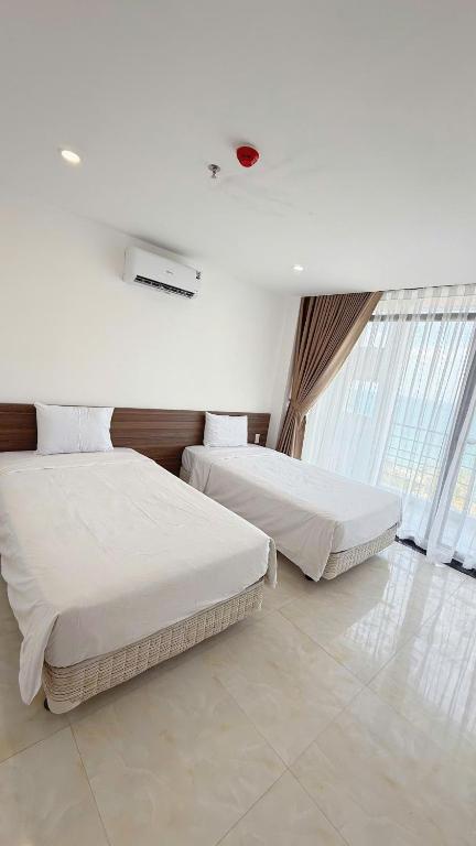 Giường trong phòng chung tại AQua Hotel & Spa