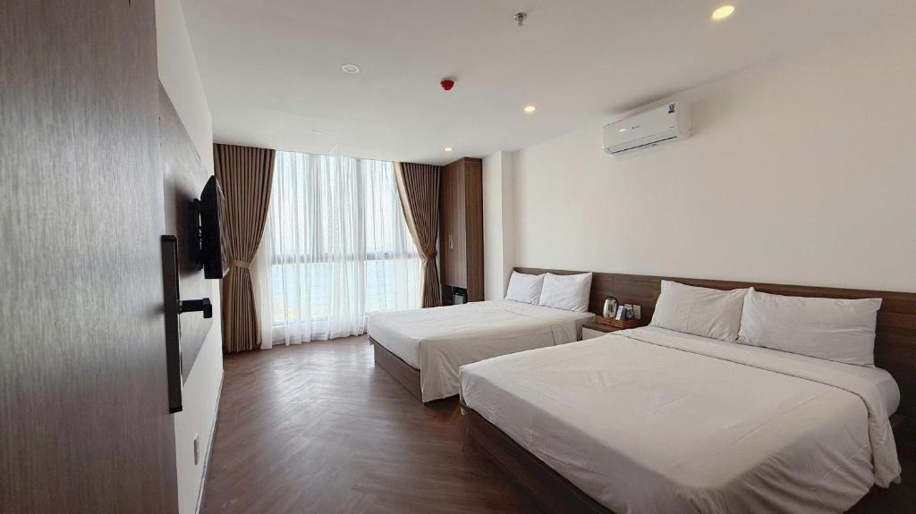 Giường trong phòng chung tại AQua Hotel & Spa
