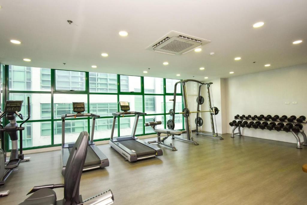 a gym with cardio equipment in a building at Condo Unit at Symphony Towers, Timog, Quezon City in Manila