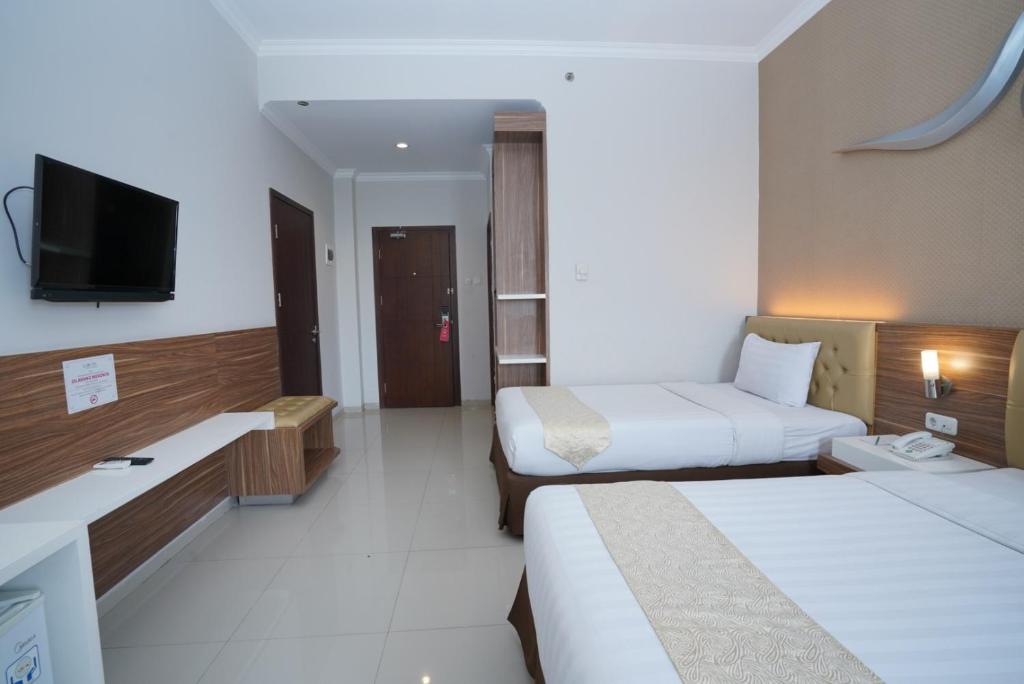 Voodi või voodid majutusasutuse Lorin Sentul Hotel toas