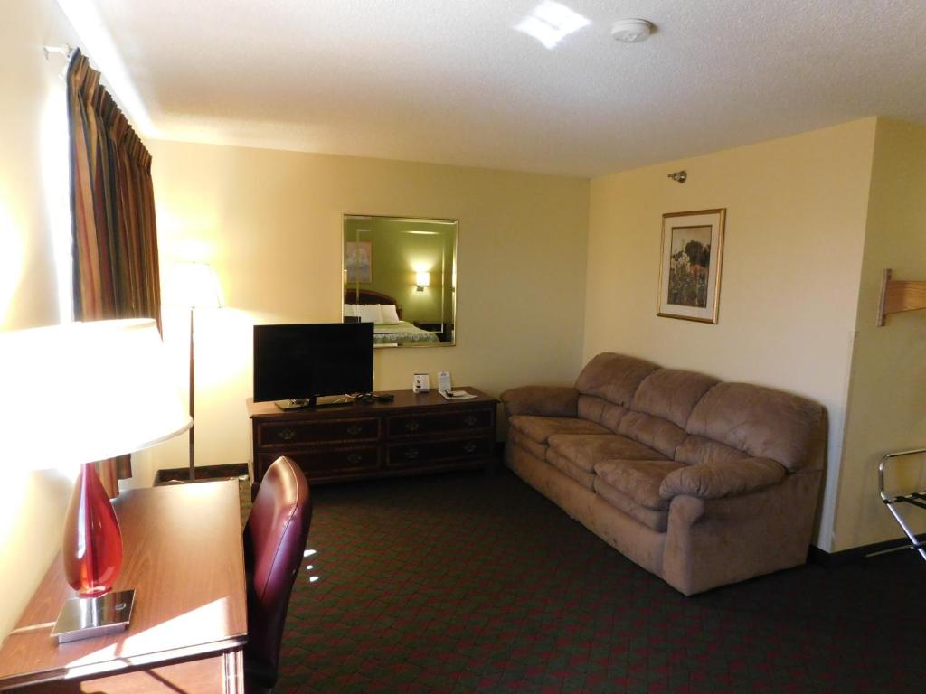 a living room with a couch and a television at Days Inn by Wyndham Lexington NE in Lexington