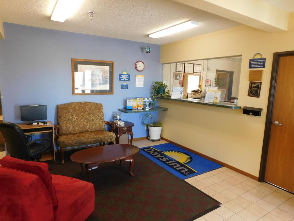 a waiting room with a couch and a chair at Days Inn by Wyndham Lexington NE in Lexington