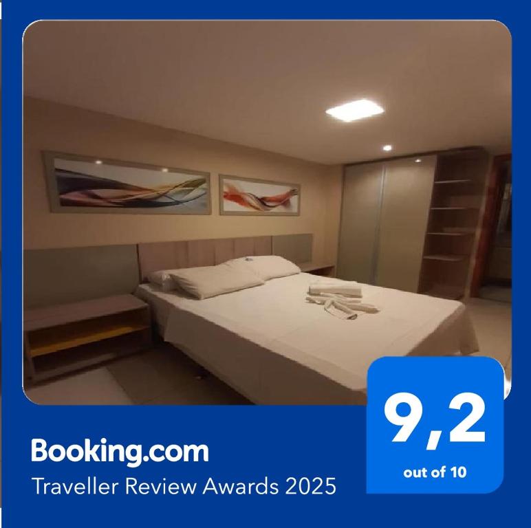 a hotel room with a bed and a mirror at Tambaú Israel Flat 417 - Beira mar in João Pessoa