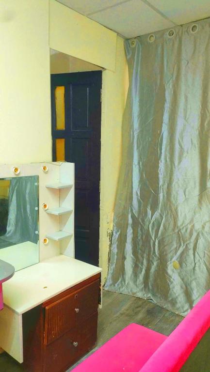 a bedroom being remodeled with a dresser and a mirror at Happy Farm Homestay in Ấp Long Ðại
