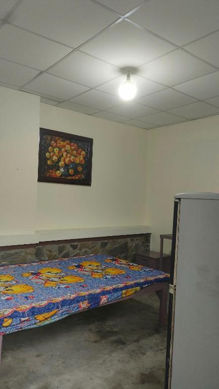 a bed in a room with a painting on the wall at Happy Farm Homestay in Ấp Long Ðại