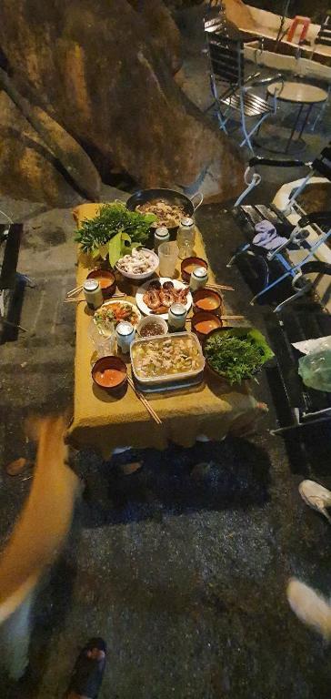 a table full of food on top at Happy Farm Homestay in Ấp Long Ðại