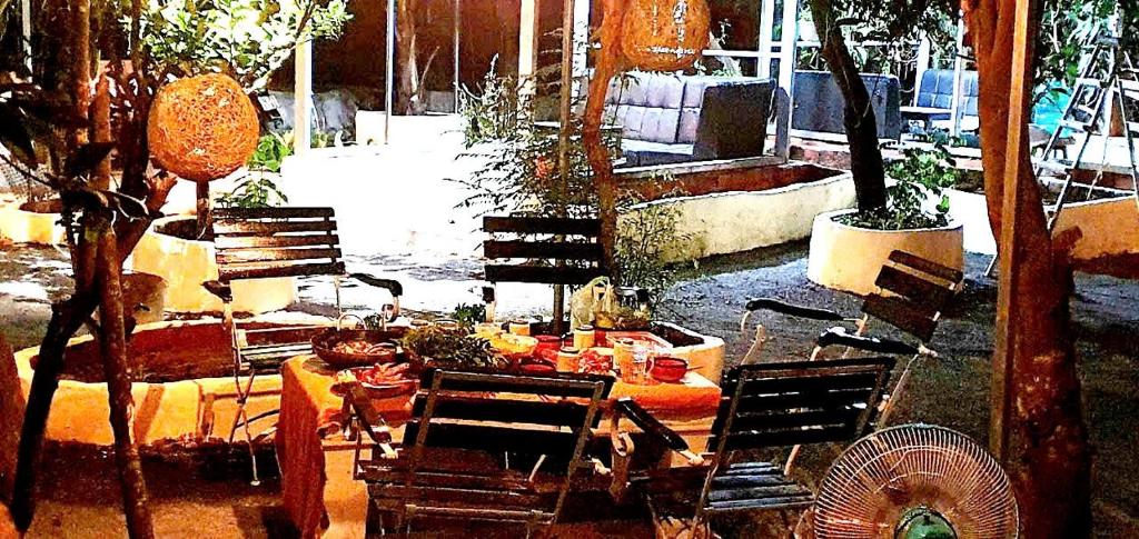 a patio with a table and chairs and a fan at Happy Farm Homestay in Ấp Long Ðại