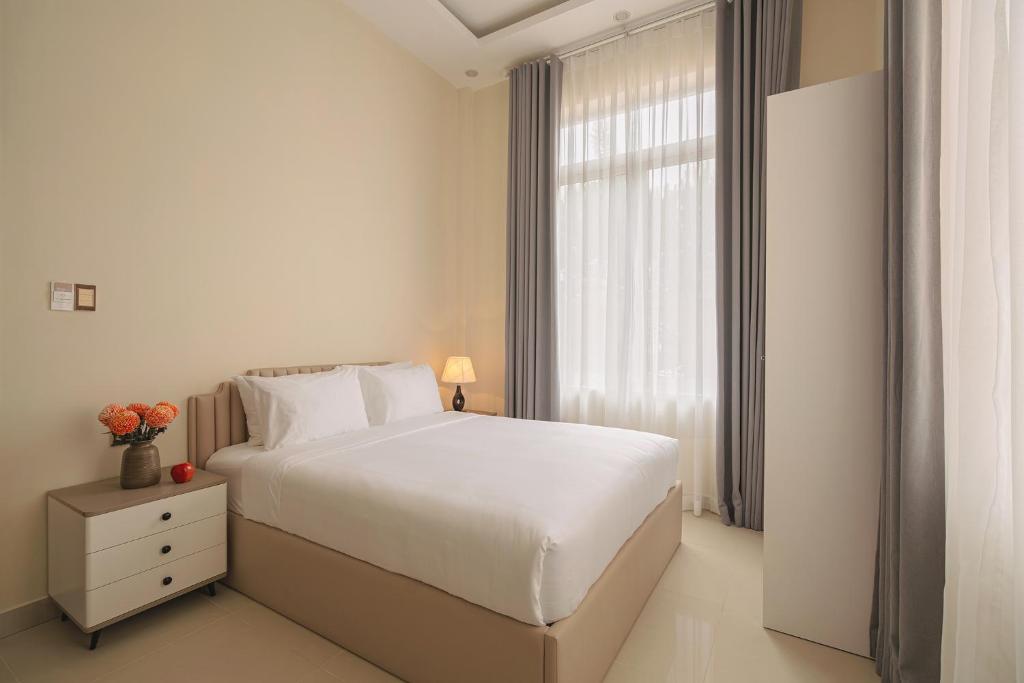 Postel nebo postele na pokoji v ubytování The One Da Lat Hotel