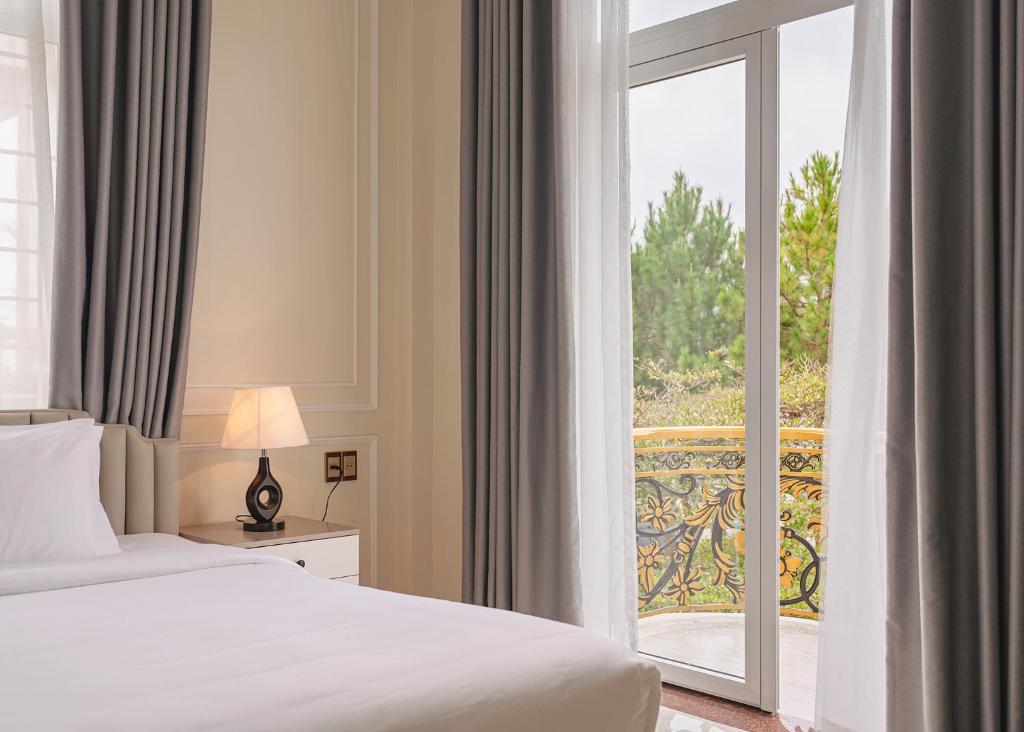 Postel nebo postele na pokoji v ubytování The One Da Lat Hotel