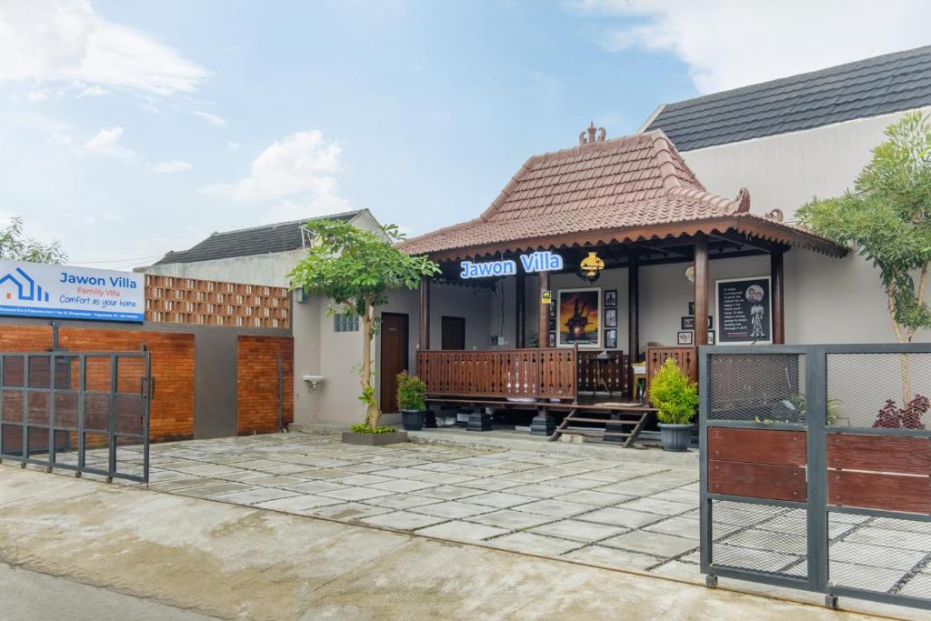 a building with a sign that reads sushi wrap at Calma Jawon Villa Jogja in Piyungan