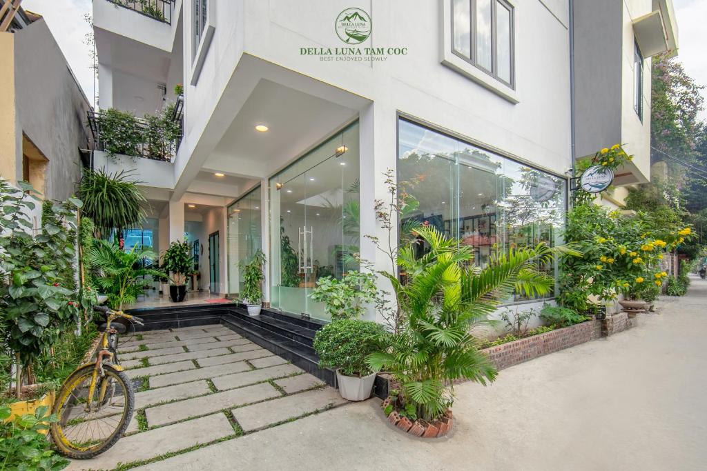 a bike parked outside of a building with plants at Della Luna Tam Coc Ninh Binh in Ninh Binh