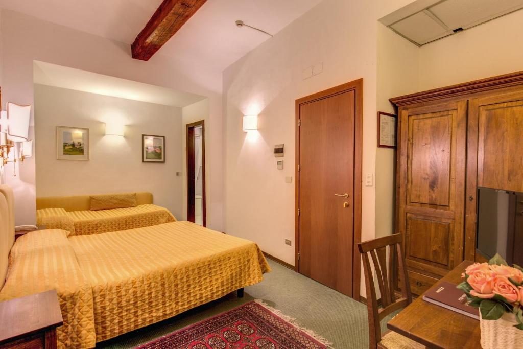 Postel nebo postele na pokoji v ubytování Hotel Rex