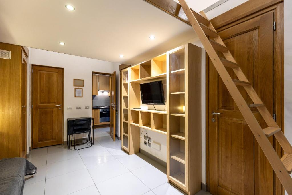 a room with a staircase and a living room at Monti House - City Center in Rome