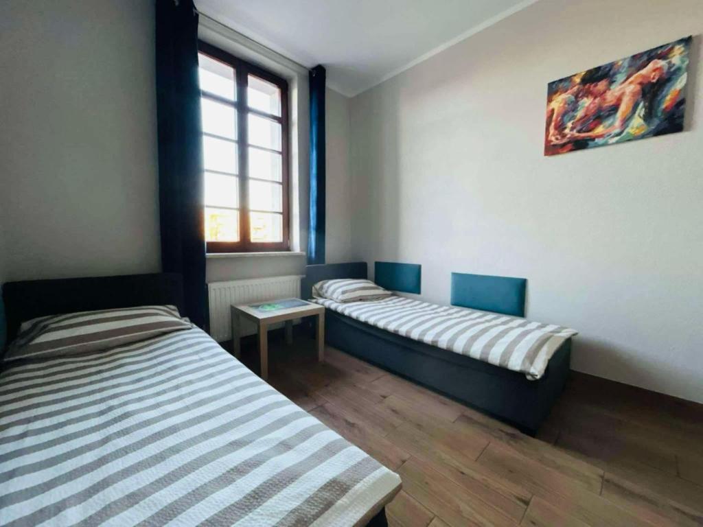 a room with two beds and a window at Open Tours in Ełk