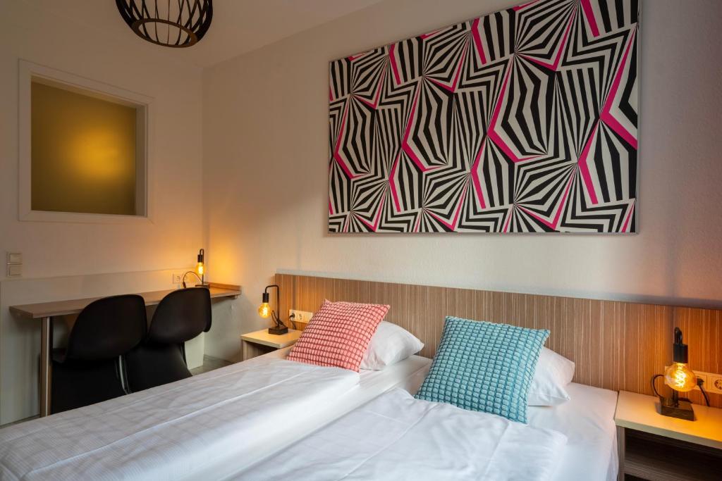 Postel nebo postele na pokoji v ubytování Hotel Madeleine Biohotel