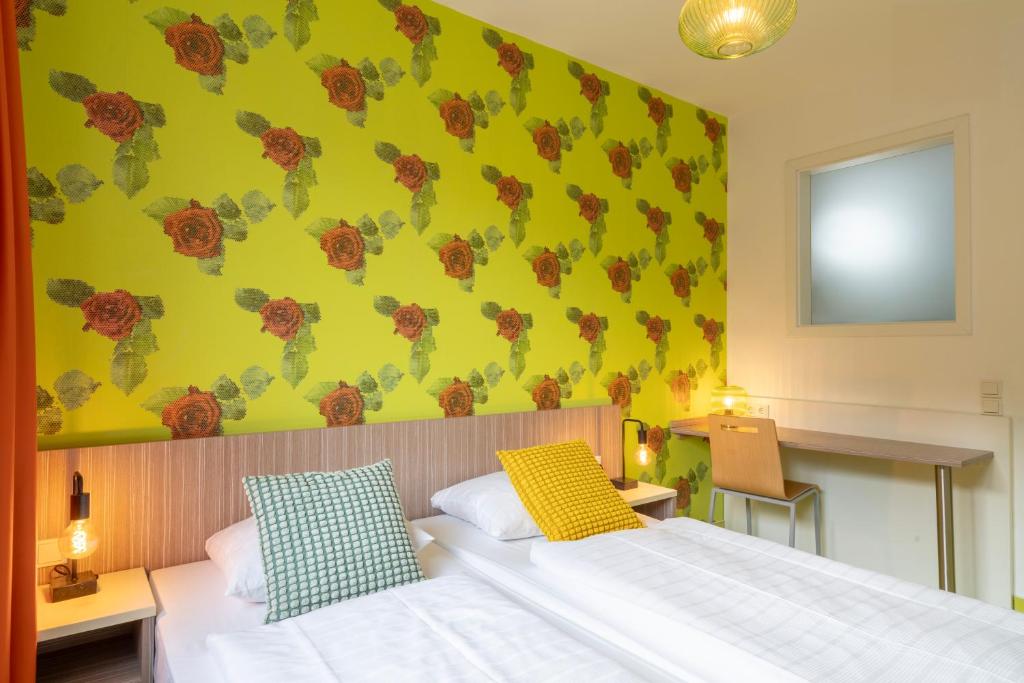 Postel nebo postele na pokoji v ubytování Hotel Madeleine Biohotel