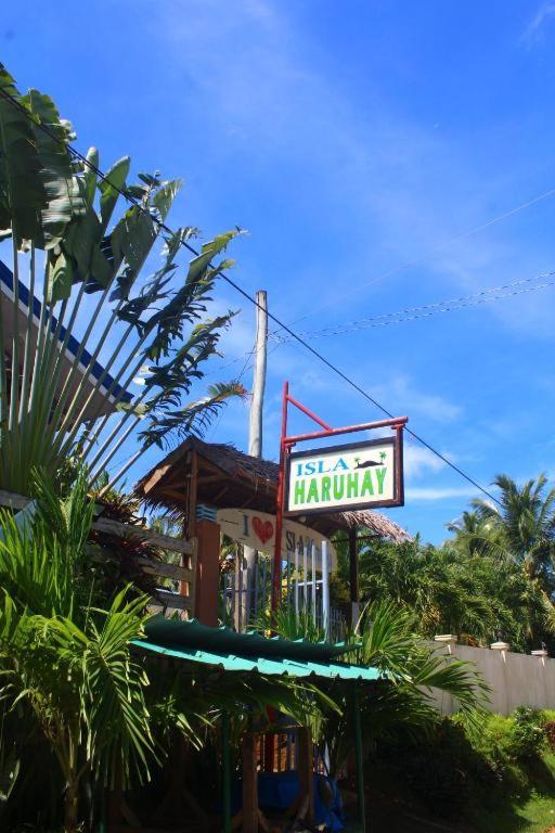 a sign for a restaurant in front of a building at Isla Haruhay in Dapa
