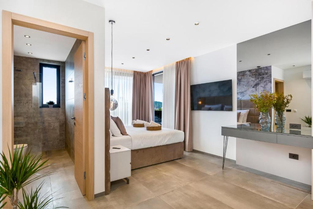 a bedroom with a king sized bed and a bathroom at Fly Room - S5 - MPolo in Medulin