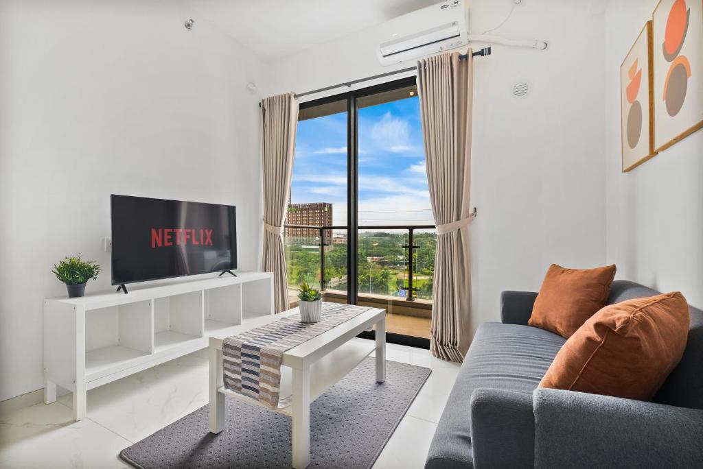 a living room with a couch and a tv at Privo by Kozystay - BSD in Tangerang